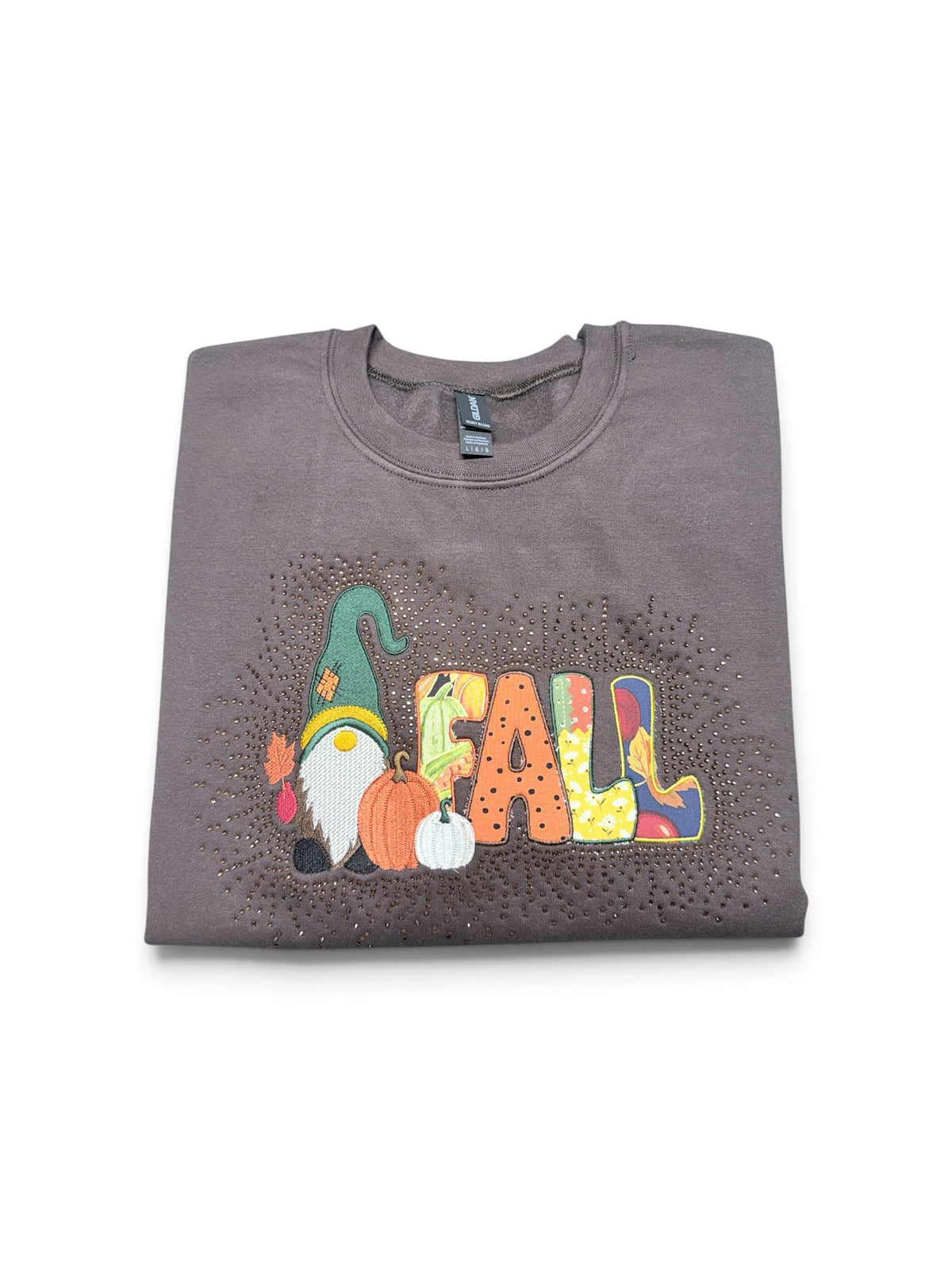 Folded brown Gildan Heavy Blend fall gnome embroidered sweatshirt with rhinestones